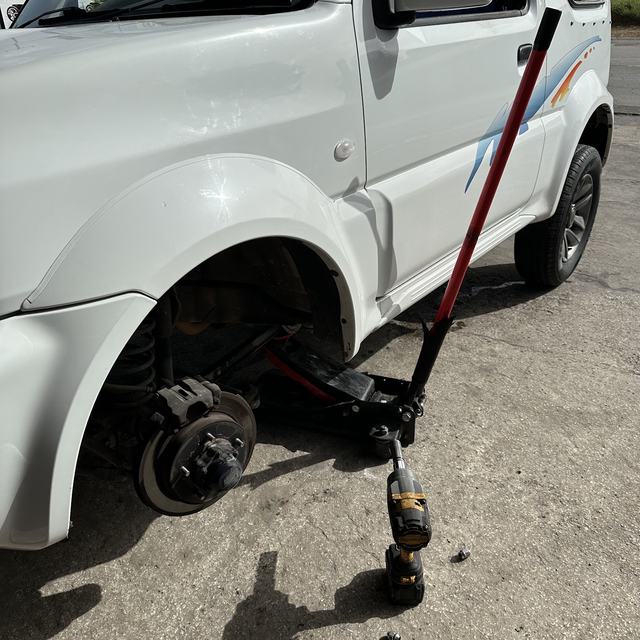 SUV jacked up with wheel off