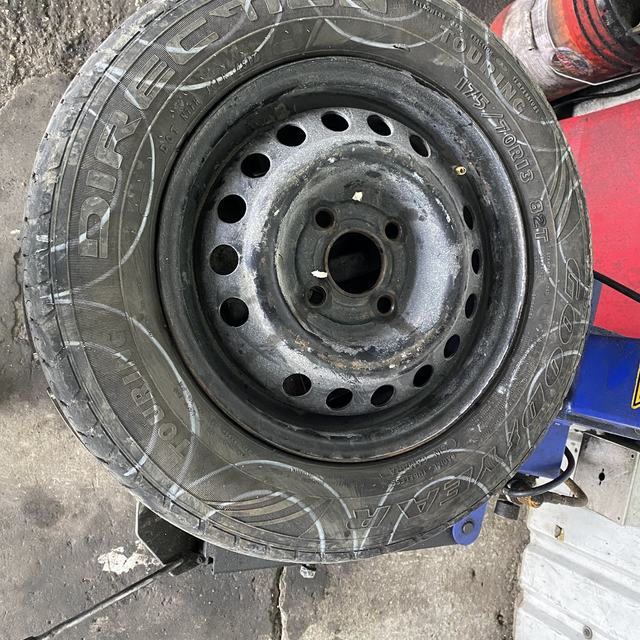 Steel rim with tyre being worked on